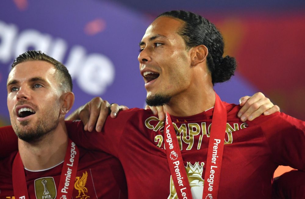 LIVERPOOL, ENGLAND - JULY 22: Jordan Henderson and Virgil van Dijk of Liverpool celebrate following the Premier League match between Liverpool FC and Chelsea FC at Anfield on July 22, 2020 in Liverpool, England. Football Stadiums around Europe remain empty due to the Coronavirus Pandemic as Government social distancing laws prohibit fans inside venues resulting in all fixtures being played behind closed doors. (Photo by Paul Ellis/Pool via Getty Images)