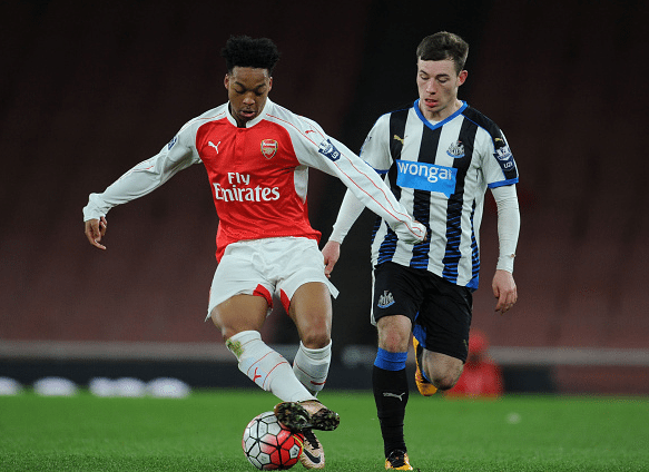 Chris Willock of Arsenal breaks past Callum Roberts of Newcastle during the Barclays Premier League match between Arsenal and Newcastle United at Emirates Stadium on April 8, 2016 in London, England.