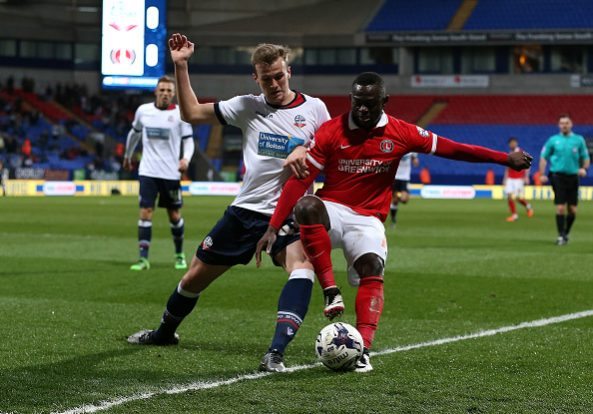 BOLTON, ENGLAND - APRIL 19:  Rob Holding of Bolton Wanderers battles with Igor Vetokele of Charlton Athletic during the Sky Bet Championship match between Bolton Wanderers and Charlton Athletic at Reebok Stadium on April 19, 2016 in Bolton, United Kingdom.  (Photo by Jan Kruger/Getty Images)