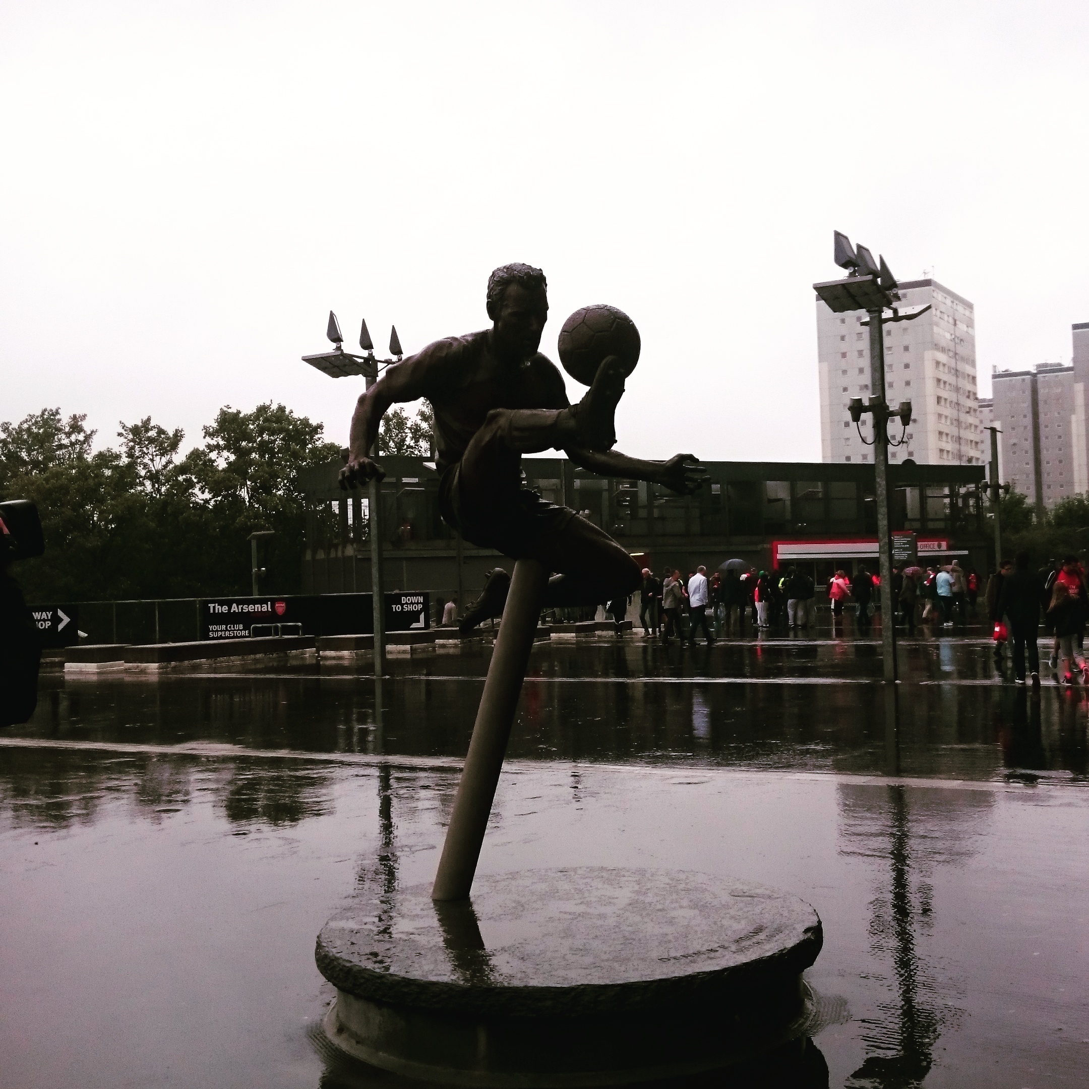 The Dennis Bergkamp statue set against the dreary September rain