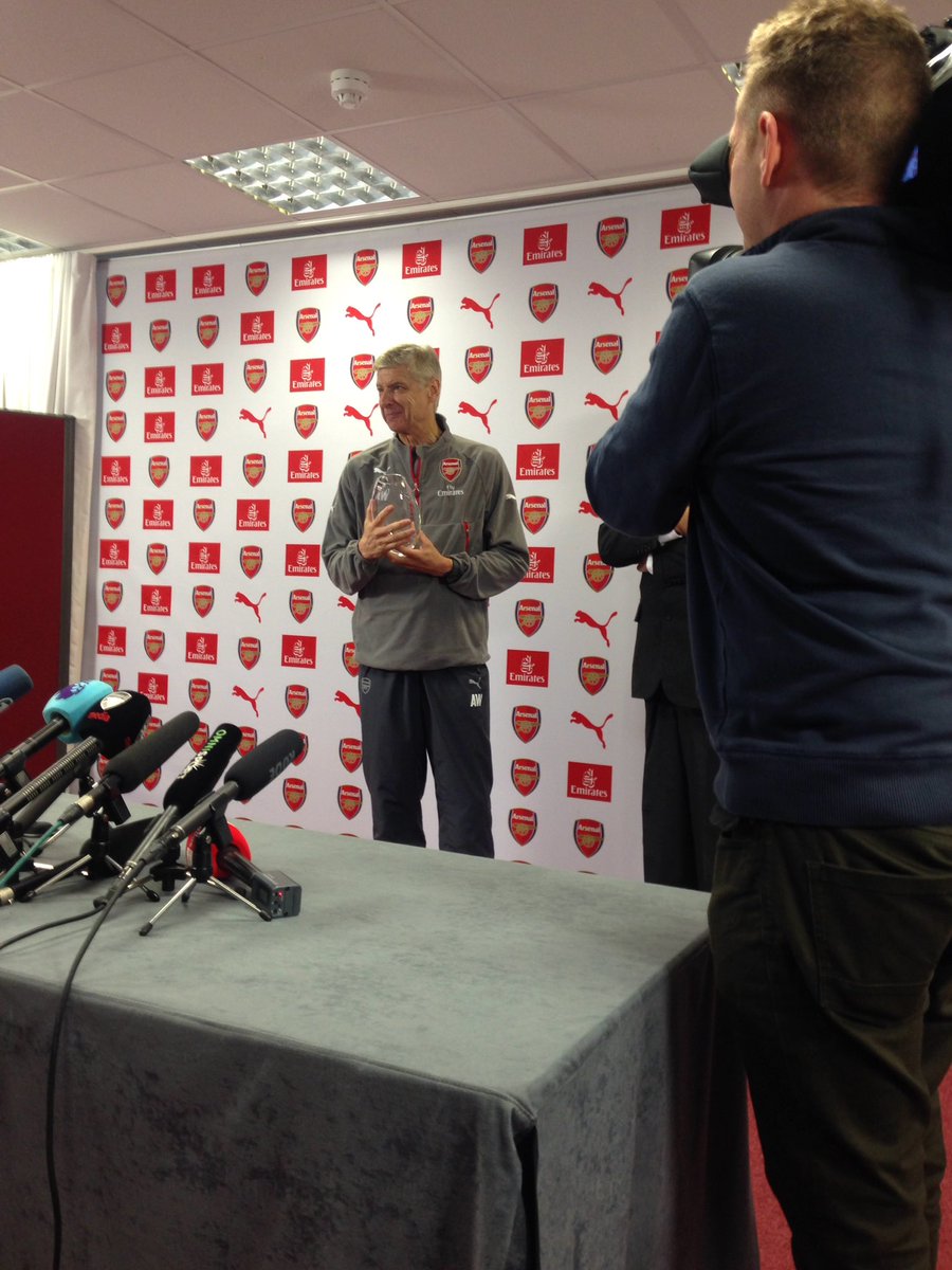 Wenger pictured with a crystal vase, received at the pre-Burnley press conference to commemorate 20 years in charge of the club. (Picture source: Twitter / James Olley)