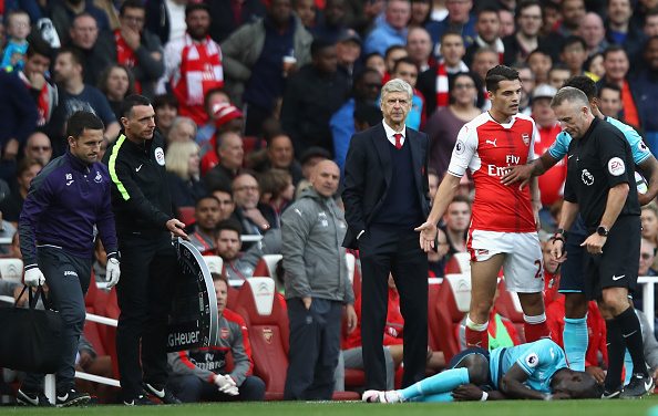 LONDON, ENGLAND - OCTOBER 15: Referee Jonathan Moss calls for a foul by Granit Xhaka of Arsenal during the Premier League match between Arsenal and Swansea City at Emirates Stadium on October 15, 2016 in London, England. (Photo by Julian Finney/Getty Images)