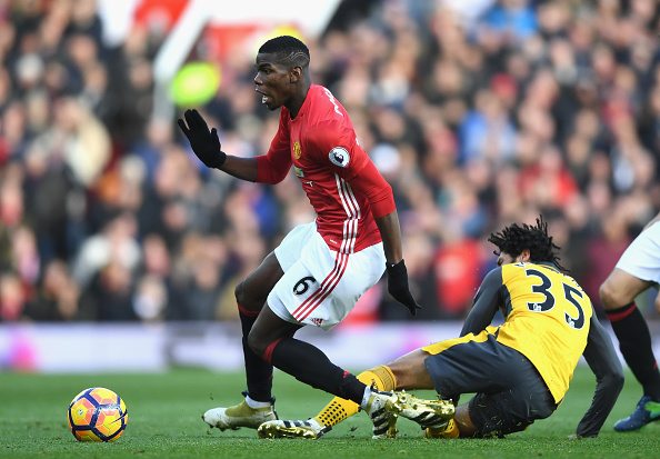 Arsenal's Egyptian midfielder Mohamed Elneny (R) tackles Manchester United's French midfielder Paul Pogba during the Premier League match between Manchester United and Arsenal at Old Trafford on November 19, 2016 in Manchester, England.