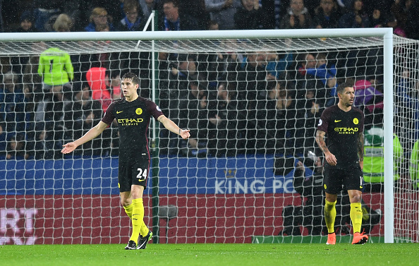 John Stones (L) and Aleksandar Kolarov look dejected, moments after Vardy completed his hat-trick to inflict further misery on City's sloppy defensive play. (Photo: Michael Reagan / Getty Images)