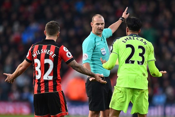 Referee Bobby Madley (C) speaks with Bournemouth's English midfielder Jack Wilshere (L) and Liverpool's German midfielder Emre Can during the English Premier League football match between Bournemouth and Liverpool at the Vitality Stadium in Bournemouth, southern England on December 4, 2016. / AFP / Glyn KIRK / RESTRICTED TO EDITORIAL USE. No use with unauthorized audio, video, data, fixture lists, club/league logos or 'live' services. Online in-match use limited to 75 images, no video emulation. No use in betting, games or single club/league/player publications. / (Photo credit should read GLYN KIRK/AFP/Getty Images)