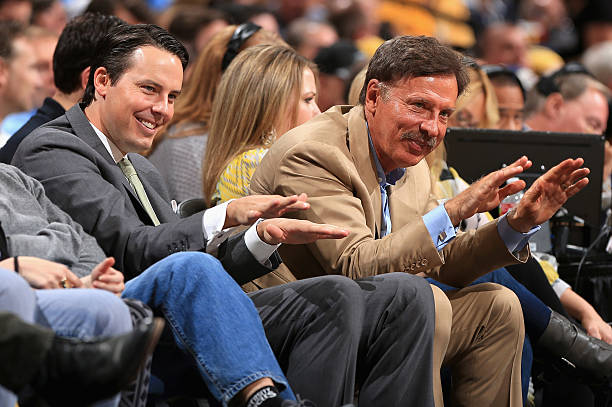 DENVER, CO - APRIL 20: (L-R) Denver Nuggets President Josh Kroenke and his father Stan Kroenke, the owner of the Denver Nuggets offer praise for Rocky, the team mascot, as they watch the game from courtside seats as the Nuggets face the Golden State Warriors during Game One of the Western Conference Quarterfinals of the 2013 NBA Playoffs at the Pepsi Center on April 20, 2013 in Denver, Colorado. The Nuggets defeated the Warriors (Photo by Doug Pensinger/Getty Images)