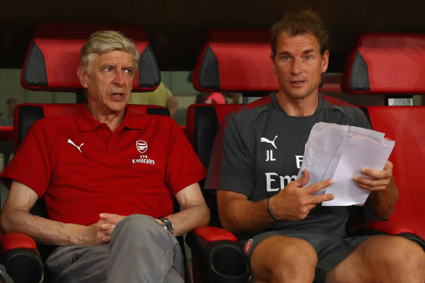 Jens Lehmann R assistant coach of Arsenal looks on with manager Arsene Wenger