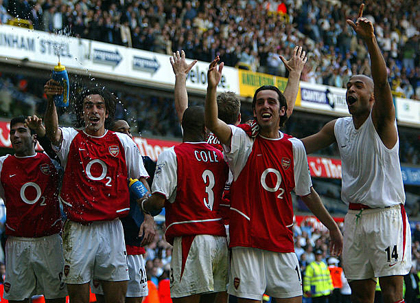 Arsenal undefeated: LONDON, UNITED KINGDOM: Arsenal's L to R facing camera Jose Antonio Reyes,Robert Pires,Edu and Thierry Henry celebrates winning the 2003/2004 Football Premier League after drawing 2-2 with Tottenham during their Premier League clash at White Hart Lane in north London, 25 April 2004. AFP PHOTO / ODD ANDERSEN