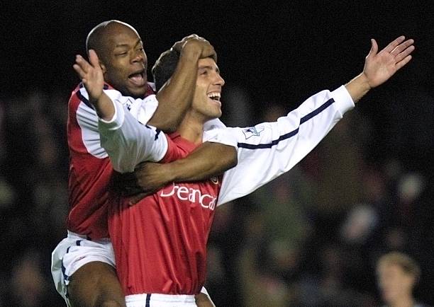 LONDON, UNITED KINGDOM: Arsenal's Sylvain Wiltord (L) jumps on teammate Edu (R) after he scored the opening goal against Grimsby Town's in The Worthington Cup 4th round match at Highbury in London 27 November 2001. AFP PHOTO Adrian DENNIS