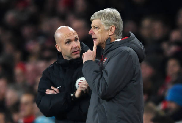 Arsene Wenger, with a finger to his chin, ponders what fourth official Anthony Taylor is saying during the Premier League match between Arsenal and Manchester United at Emirates Stadium on December 2, 2017 in London, England. (Photo by Laurence Griffiths/Getty Images)