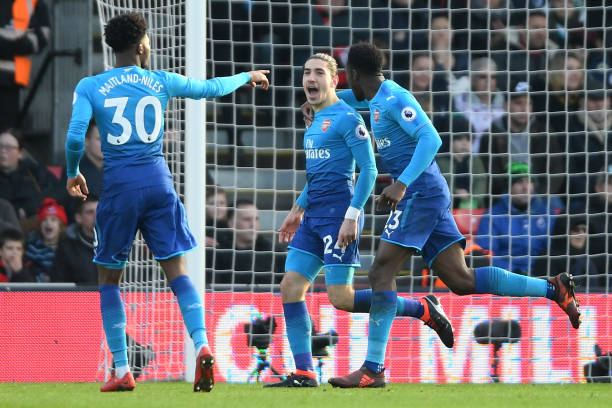 BOURNEMOUTH, ENGLAND - JANUARY 14: Hector Bellerin of Arsenal celebrates scoring his sides first goal with Danny Welbeck and Ainsley Maitland-Niles of Arsenal during the Premier League match between AFC Bournemouth and Arsenal at Vitality Stadium on January 14, 2018 in Bournemouth, England. (Photo by Mike Hewitt/Getty Images)