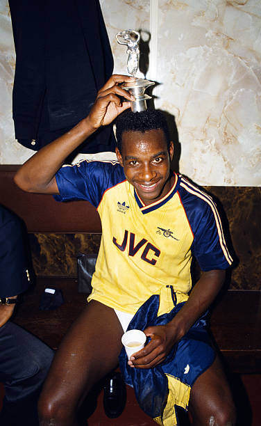 LIVERPOOL, UNITED KINGDOM - MAY 26: Arsenal goalscorer Michael Thomas celebrates in the dressing room with the Championship trophy lid after his goal sealed a 2-0 victory over rivals Liverpool to win the 1988/89 Football League title at Anfield on May 26, 1989 in Liverpool, England. (Photo by Allsport/Getty Images)