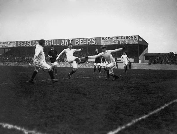 Woolwich Arsenal goalkeeper Harold Crawford reaches for a shot from a Manchester City striker during a game at Arsenal's Plumstead ground in South London, 2nd November 1912. (Photo by Topical Press Agency/Getty Images)