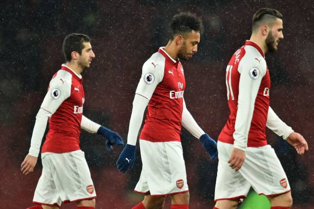Arsenal's Armenian midfielder Henrikh Mkhitaryan (L), Arsenal's Gabonese striker Pierre-Emerick Aubameyang (C) and Arsenal's German-born Bosnian defender Sead Kolasinac (R) leave the pitch after the English Premier League football match between Arsenal and Manchester City at the Emirates Stadium in London on March 1, 2018. Manchester City won the game 3-0. / AFP PHOTO / Glyn KIRK / 