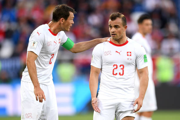 KALININGRAD, RUSSIA - JUNE 22: Stephan Lichtsteiner of Switzerland speaks with Xherdan Shaqiri of Switzerland during the 2018 FIFA World Cup Russia group E match between Serbia and Switzerland at Kaliningrad Stadium on June 22, 2018 in Kaliningrad, Russia. (Photo by Matthias Hangst/Getty Images)