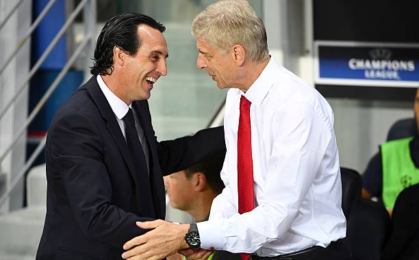 Paris Saint-Germain's Spanish head coach Unai Emery (L) shakes hands with Arsenal's French manager Arsene Wenger during the UEFA Champions League Group A football match between Paris-Saint-Germain and Arsenal FC on September 13, 2016 at the Parc des Princes stadium in Paris.