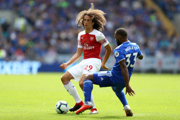CARDIFF, WALES - SEPTEMBER 02: Matteo Guendouzi of Arsenal is faced by Junior Hoilett of Cardiff City during the Premier League match between Cardiff City and Arsenal FC at Cardiff City Stadium on September 2, 2018 in Cardiff, United Kingdom. (Photo by Clive Rose/Getty Images)