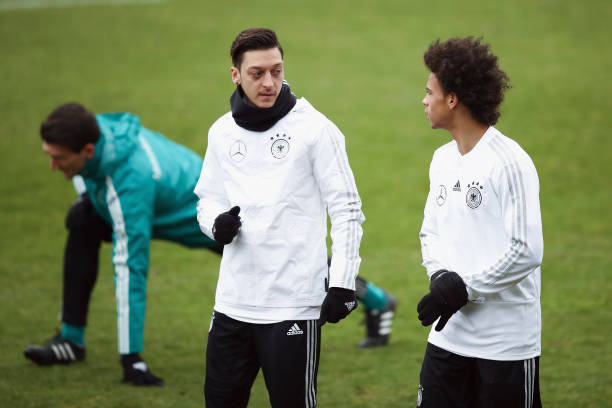DUESSELDORF, GERMANY - MARCH 21: Mesut Oezil (L) and Leroy Sane chat during a Germany training session ahead of their international friendly match against Spain at Paul-Janes-Stadion on March 21, 2018 in Duesseldorf, Germany. (Photo by Maja Hitij/Bongarts/Getty Images)
