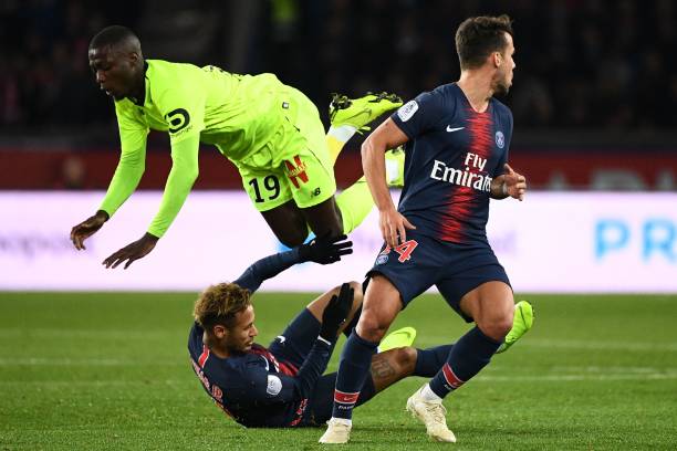 Lille's Ivorian forward Nicolas Pepe (up) flies over Paris Saint-Germain's Brazilian forward Neymar (down) after vying for the ball during the French L1 football match between Paris Saint-Germain (PSG) and Lille (LOSC) at the Parc des Princes stadium, in Paris, November 2, 2018. (Photo by FRANCK FIFE / AFP) (Photo credit should read FRANCK FIFE/AFP/Getty Images)