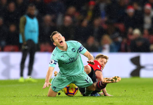 SOUTHAMPTON, ENGLAND - DECEMBER 16: Stephan Lichtsteiner of Arsenal is tackled by Stuart Armstrong of Southampton during the Premier League match between Southampton FC and Arsenal FC at St Mary's Stadium on December 16, 2018 in Southampton, United Kingdom. (Photo by Catherine Ivill/Getty Images)