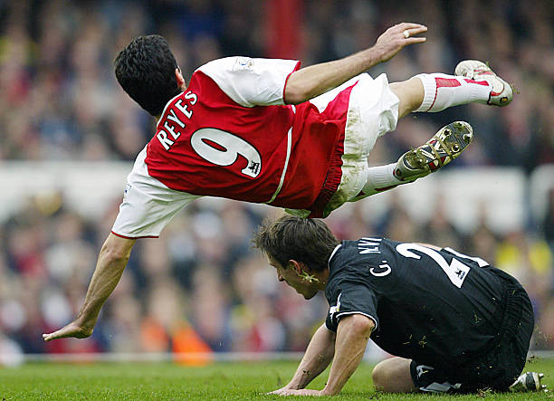 LONDON, UNITED KINGDOM: Arsenal's Jose Reyes (top) flies over Gary Neville of Manchester United during their FA Premier League clash at Highbury in London, 28 March 2004. AFP PHOTO / ODD