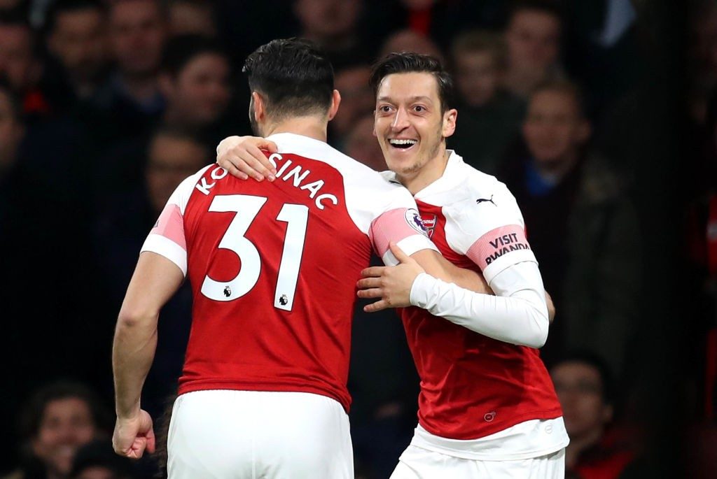 LONDON, ENGLAND - FEBRUARY 27: Mesut Ozil of Arsenal celebrates after scoring his team's first goal with Sead Kolasinac of Arsenal during the Premier League match between Arsenal FC and AFC Bournemouth at Emirates Stadium on February 27, 2019 in London, United Kingdom. (Photo by Catherine Ivill/Getty Images)
