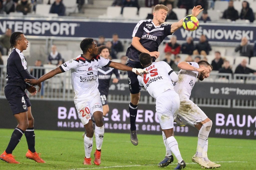 Bordeaux's Danish forward Andreas Cornelius (C-R) tries to score a goal with his hand during the French L1 football match between Girondins de Bordeaux (FCGB) and En avant de Guingamp (EAG) on February 20, 2019 at the Matmut Atlantique stadium in Bordeaux, southwestern France. (Photo by NICOLAS TUCAT / AFP / Getty Images)