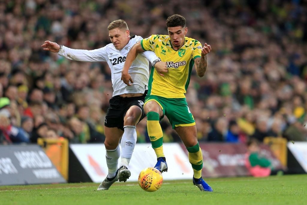 NORWICH, ENGLAND - DECEMBER 29: Ben Godfrey of Norwich City and Martyn Harrison of Derby County compete for the ball during the Sky Bet Championship match between Norwich City and Derby County at Carrow Road on December 29, 2018 in Norwich, England. (Photo by Stephen Pond/Getty Images)