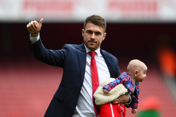 LONDON, ENGLAND - MAY 05: Aaron Ramsey of Arsenal, holding one of his children, acknowledges the crowd as he says farewell to the club following the Premier League match between Arsenal FC and Brighton & Hove Albion at Emirates Stadium on May 05, 2019 in London, United Kingdom. (Photo by Clive Mason/Getty Images)