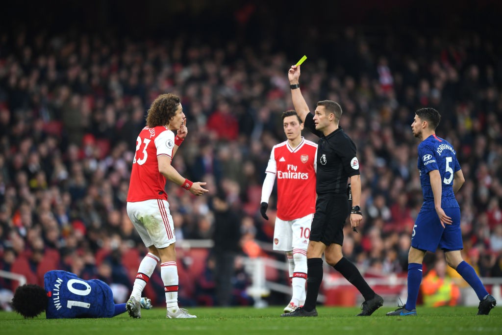 LONDON, ENGLAND - DECEMBER 29: Referee Craig Pawson shows a yellow card to David Luiz of Arsenal during the Premier League match between Arsenal FC and Chelsea FC at Emirates Stadium on December 29, 2019, in London, United Kingdom. (Photo by Shaun Botterill/Getty Images)
