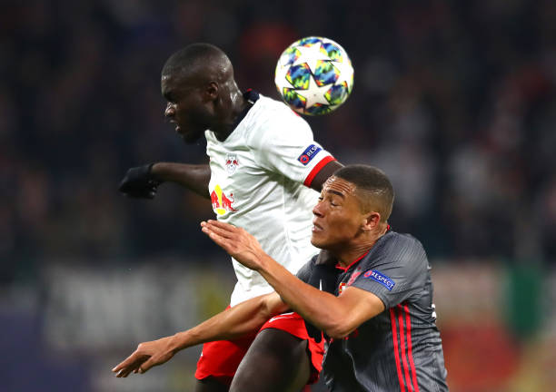 LEIPZIG, GERMANY - NOVEMBER 27: Dayot Upamecano of RB Leipzig battles for possession with Carlos Vinicius of Benfica during the UEFA Champions League group G match between RB Leipzig and SL Benfica at Red Bull Arena on November 27, 2019 in Leipzig, Germany. (Photo by Martin Rose/Bongarts/Getty Images)