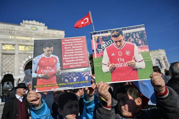 Supporters of China's Muslim Uighur minority hold placards of Arsenal's Turkish origin German midfielder Mesut Ozil during a demonstration at Beyazid square in Istanbul on December 14, 2019. - Arsenal's Mesut Ozil, a German footballer of Turkish origin, expressed on December 14, 2019 support for Uighurs in Xinjiang and criticised Muslim countries for their failure to speak up for them. (Photo by Ozan KOSE / AFP) (Photo by OZAN KOSE/AFP via Getty Images)
