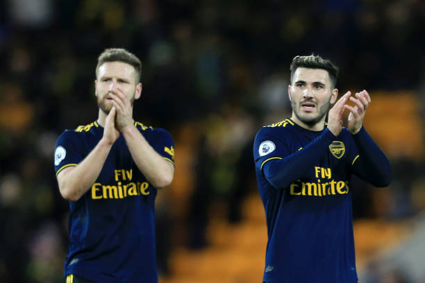NORWICH, ENGLAND - DECEMBER 01: Sead Kolasinac of Arsenal and Shkodran Mustafi of Arsenal acknowledge the fans during the Premier League match between Norwich City and Arsenal FC at Carrow Road on December 01, 2019 in Norwich, United Kingdom. (Photo by Stephen Pond/Getty Images)