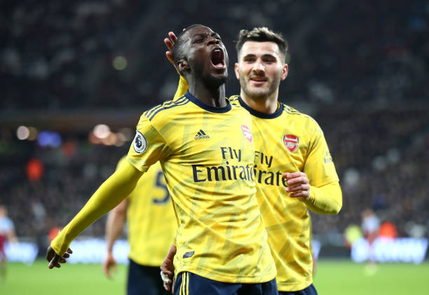 LONDON, ENGLAND - DECEMBER 09: Nicolas Pepe of Arsenal celebrates after scoring his sides second goal with Saed Kolasinac during the Premier League match between West Ham United and Arsenal FC at London Stadium on December 09, 2019 in London, United Kingdom. (Photo by Julian Finney/Getty Images)