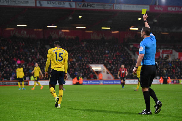 BOURNEMOUTH, ENGLAND - DECEMBER 26: Ainsley Maitland-Niles of Arsenal is shown a yellow card by referee Stuart Attwell during the Premier League match between AFC Bournemouth and Arsenal FC at Vitality Stadium on December 26, 2019 in Bournemouth, United Kingdom. (Photo by Dan Mullan/Getty Images)