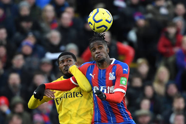 Arsenal's English midfielder Ainsley Maitland-Niles (L) vies with Crystal Palace's Ivorian striker Wilfried Zaha during the English Premier League football match between Crystal Palace and Arsenal at Selhurst Park in south London on January 11, 2020. (Photo by DANIEL LEAL-OLIVAS / AFP) 