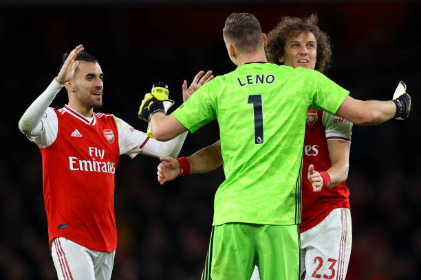 Dani Ceballos, David Luiz and Bernd Leno of Arsenal celebrate victory during the Premier League match between Arsenal FC and Everton FC at Emirates Stadium on February 23, 2020 in London, United Kingdom.