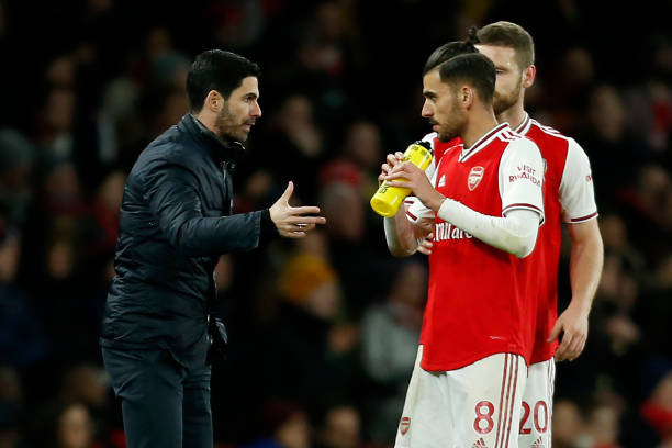 Arsenal's Spanish head coach Mikel Arteta (L) talks with Arsenal's Spanish midfielder Dani Ceballos (2nd R) during the English Premier League football match between Arsenal and Newcastle United at the Emirates Stadium in London on February 16, 2020.