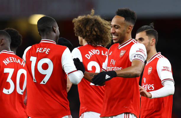 Pierre-Emerick Aubameyang of Arsenal celebrates with Nicolas Pepe after he scores his sides first goal during the Premier League match between Arsenal FC and Newcastle United at Emirates Stadium on February 16, 2020 in London, United Kingdom.