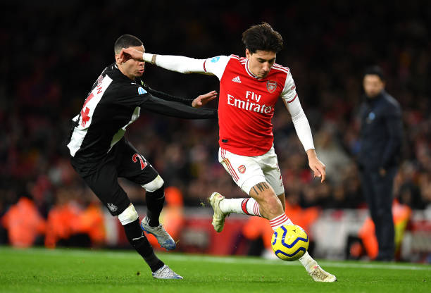 Hector Bellerin of Arsenal takes on Miguel Almiron of Newcastle United during the Premier League match between Arsenal FC and Newcastle United at Emirates Stadium on February 16, 2020 in London, United Kingdom.