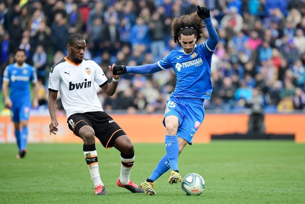 Getafe's Spanish defender Marc Cucurella (R) vies with Valencia's Central African Republic-French midfielder Geoffrey Kondogbia during the Spanish league football match between Getafe CF and Valencia CF at the Col. Alfonso Perez stadium in Getafe on February 8, 2020. (Photo by JAVIER SORIANO / AFP)