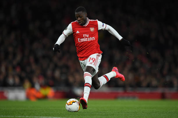 Nicolas Pepe of Arsenal FC runs with the ball during the UEFA Europa League round of 32 second leg match between Arsenal FC and Olympiacos FC at Emirates Stadium on February 27, 2020 in London, United Kingdom.