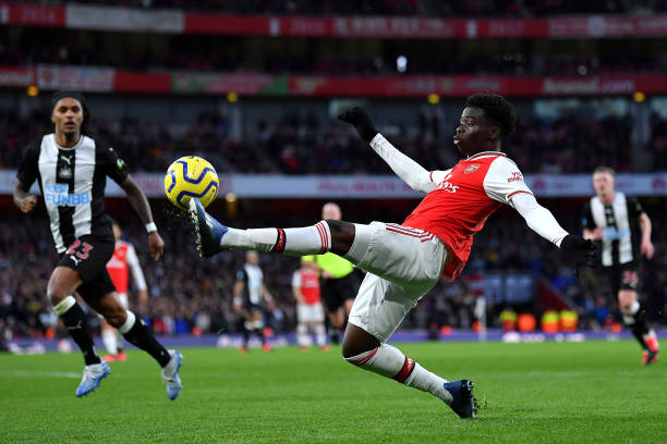 Bukayo Saka of Arsenal stretches for the ball during the Premier League match between Arsenal FC and Newcastle United at Emirates Stadium on February 16, 2020 in London, United Kingdom.