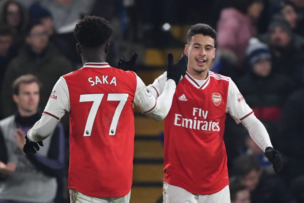 Arsenal's Brazilian striker Gabriel Martinelli (R) celebrates scoring their first goal to equalise 1-1 with Arsenal's English striker Bukayo Saka (L) during the English Premier League football match between Chelsea and Arsenal at Stamford Bridge in London on January 21, 2020. (Photo by DANIEL LEAL-OLIVAS / AFP)
