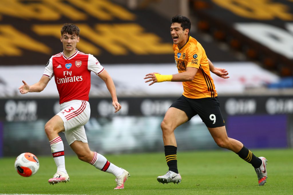 Wolverhampton Wanderers' Mexican striker Raul Jimenez (R) and Arsenal's Scottish defender Kieran Tierney (L) chase the ball during the English Premier League football match between Wolverhampton Wanderers and Arsenal at the Molineux stadium in Wolverhampton, central England on July 4, 2020. (Photo by Michael Steele / POOL / AFP) / RESTRICTED TO EDITORIAL USE. No use with unauthorized audio, video, data, fixture lists, club/league logos or 'live' services. Online in-match use limited to 120 images. An additional 40 images may be used in extra time. No video emulation. Social media in-match use limited to 120 images. An additional 40 images may be used in extra time. No use in betting publications, games or single club/league/player publications. / (Photo by MICHAEL STEELE/POOL/AFP via Getty Images)