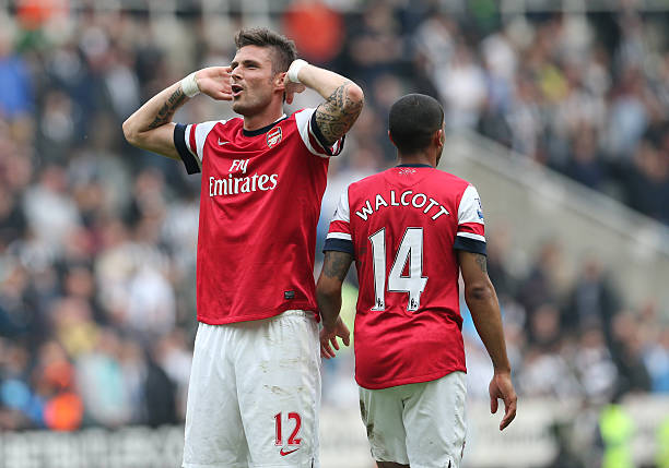 Arsenal's French striker Olivier Giroud (L) and Arsenal's English midfielder Theo Walcott (R) celebrate their victory after the final whistle in the English Premier League football match between Newcastle United and Arsenal at St James' Park in Newcastle Upon Tyne, northeast England, on May 19, 2013 (Ian MacNicol/AFP/Getty Images)