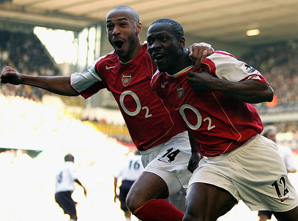 LONDON - NOVEMBER 13: Lauren of Arsenal (R) celebrates with Thierry Henry during the Barclays Premiership match between Tottenham Hotspur and Arsenal at White Hart Lane on November 13, 2004 in London, England. (Photo by Ian Walton/Getty Images)