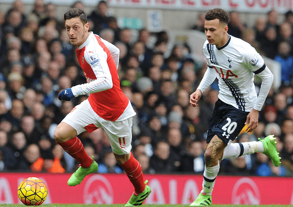 Mesut Ozil of Arsenal takes on Dele Alli of Tottenham during the Barclays Premier League match between Tottenham Hotspur and Arsenal at White Hart ...