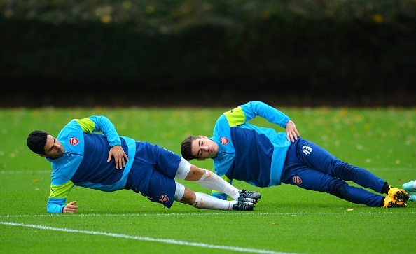 Arsenal's Spanish midfielder Mikel Arteta (L) and Spanish defender Hector Bellerin (R) attend a training session at the London Colney, North London, on November 3, 2014, on the eve of the UEFA Champions League Group D football match between Arsenal and Anderlecht. AFP PHOTO/GLYN KIRK (Photo credit should read GLYN KIRK/AFP/Getty Images)