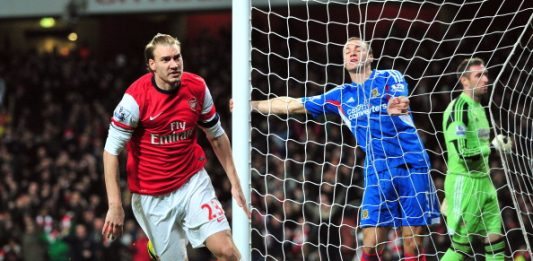 Arsenal's Danish striker Nicklas Bendtner celebrates scoring the opening goal of the English Premier League football match between Arsenal and Hull City at The Emirates Stadium in north London on December 4, 2013. AFP PHOTO/GLYN KIRK RESTRICTED TO EDITORIAL USE. NO USE WITH UNAUTHORIZED AUDIO, VIDEO, DATA, FIXTURE LISTS, CLUB/LEAGUE LOGOS OR LIVE SERVICES. ONLINE IN-MATCH USE LIMITED TO 45 IMAGES, NO VIDEO EMULATION. NO USE IN BETTING, GAMES OR SINGLE CLUB/LEAGUE/PLAYER PUBLICATIONS. (Photo credit should read GLYN KIRK/AFP/Getty Images)